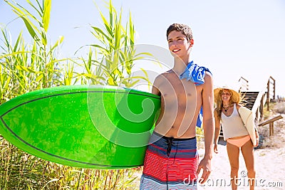 Teenager surfers waling to the beach Stock Photo