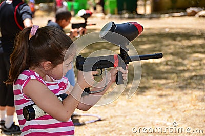 Teenager in a target practice with a paintball gun Stock Photo