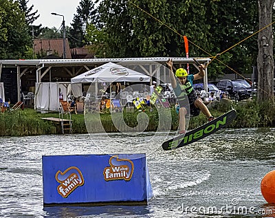 Teenager wakeboarding on a lake - Brwinow, Masovia, Poland Editorial Stock Photo
