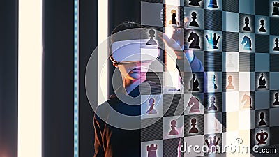 Teenager with headset playing VR chess Stock Photo