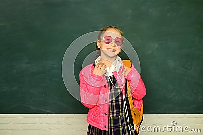 Teenager younf school girl with backpack. Portrait of a teen female student. Funny school girl wearing eyeglasses Stock Photo