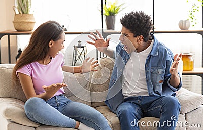 Teenagers boy and girl quarreling, gesticulating and shouting at each other Stock Photo