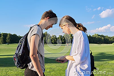 Teenagers friends talking looking at smartphone screen Stock Photo