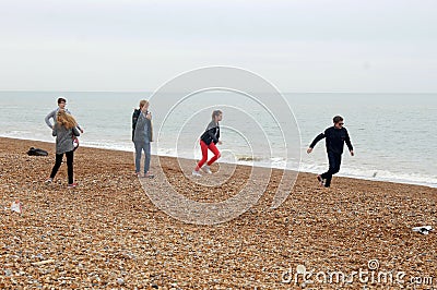 Teenagers having fun on Hastings beach Editorial Stock Photo