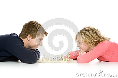 Teenagers lying down playing chess Stock Photo