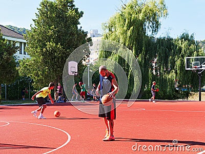 Teenagers playing basketball on playground Editorial Stock Photo