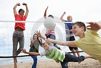 Teenagers playing volleyball Stock Photo