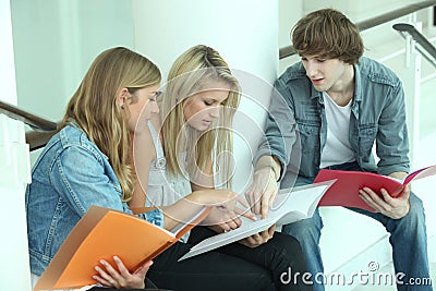Teenagers sitting on steps Stock Photo