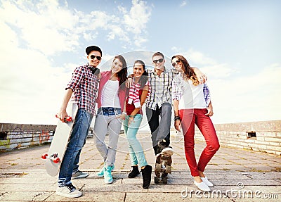 Teenagers with skates outside Stock Photo