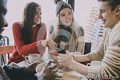 Teenagers Socialising In A Winter Cafe Stock Photo