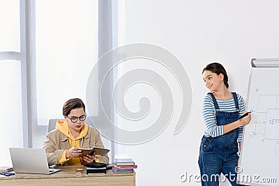 teenagers studying together in living room Stock Photo