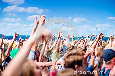 Teenagers at summer music festival clapping and singing Stock Photo