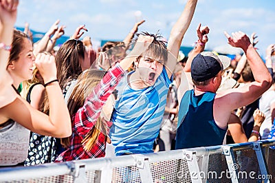 Teenagers at summer music festival having good time Stock Photo