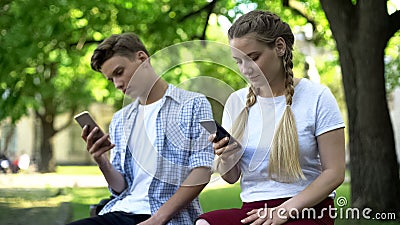 Teenagers using phone instead of interacting, lack of communication, addicted Stock Photo