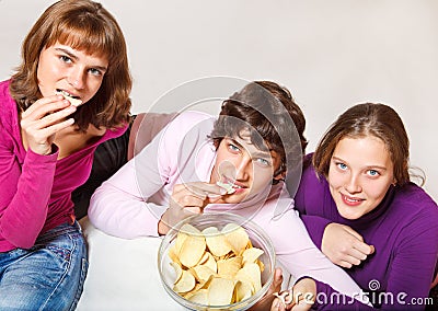 Teens eating crisps Stock Photo