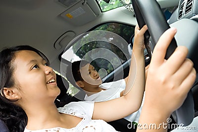 Teens enjoy driving a car Stock Photo