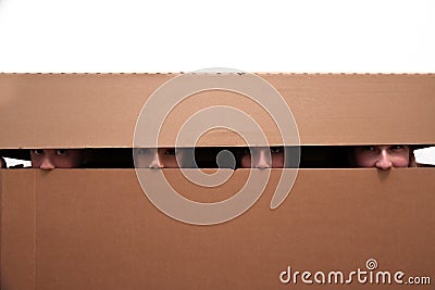 Teens hidden in moving box Stock Photo