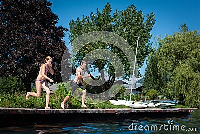 Teens jumping into lake Stock Photo