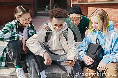 Teens watching video content together Stock Photo