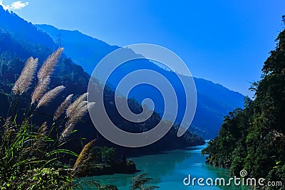 Teesta river flowing down from Sikkim to Darjeeling district with lush green hills and mountains Stock Photo