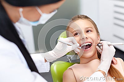 Teeth checkup at dentist's office. Dentist examining girls teeth Stock Photo