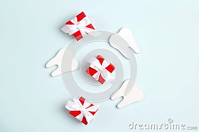 Teeth and gift boxes on a blue background. Happy Dentist`s Day concept Stock Photo