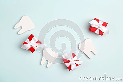 Teeth and gift boxes in the form of a smile on a blue background. Happy Dentist`s Day concept Stock Photo