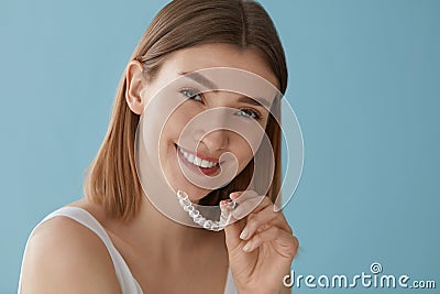 Teeth whitening. Woman with healthy teeth using removable braces Stock Photo