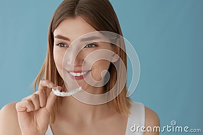 Teeth whitening. Woman with healthy teeth using removable braces Stock Photo