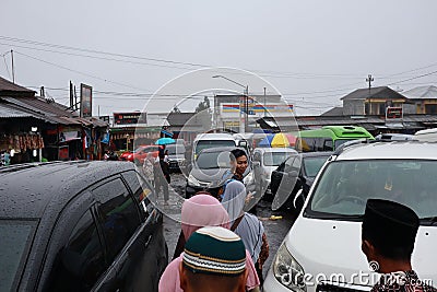 Tegal, January 2023. Group photo on the way to Guci tourist spot. with the density of visitors, busy parking vehicles and various Editorial Stock Photo