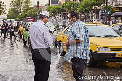 Policeman checks driver`s license of driver, Tehran, Iran. Editorial Stock Photo