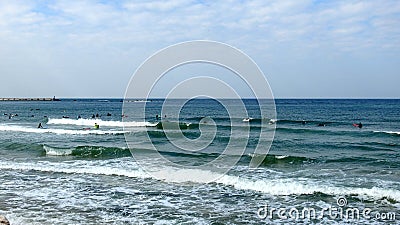 Tel Aviv. Blue sky. White clouds. Birch water. The sun. The waves. Surfing. Stock Photo