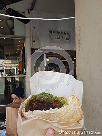 TEL AVIV, ISRAEL - Aug 06, 2019: Falafel sandwich at Miznon, Tel Aviv, Israel Editorial Stock Photo