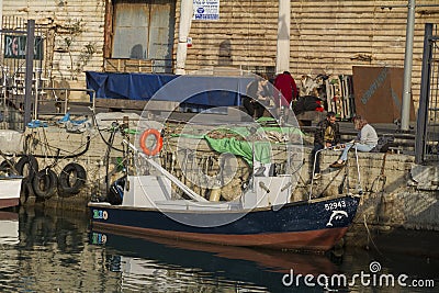 TEL AVIV, ISRAEL - MARCH 2, 2017 : People sitting on the pier of Jaffa old port in tel aviv Editorial Stock Photo