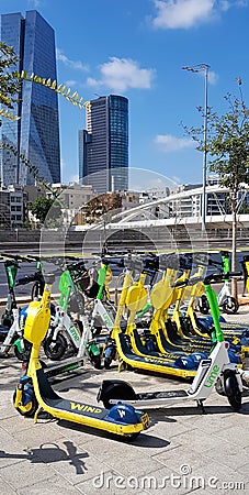 TEL AVIV, ISRAEL - October 09, 2021: Downtown view from Yigal Alon Street. Parking of bicycles, bikes and rental electric scooters Editorial Stock Photo