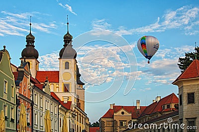 TELC, THE CZECH REPUBLIC-AUGUST 26, 2017: One hot air balloon flies over a medieval castle of Telc. Editorial Stock Photo