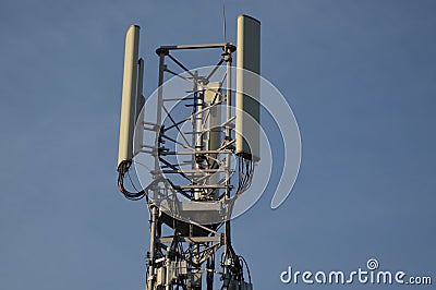 A Telecommunication antenna mast with blue sky background, France Stock Photo