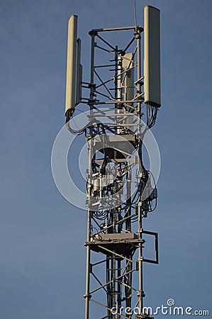 A Telecommunication antenna mast with blue sky background, France Stock Photo