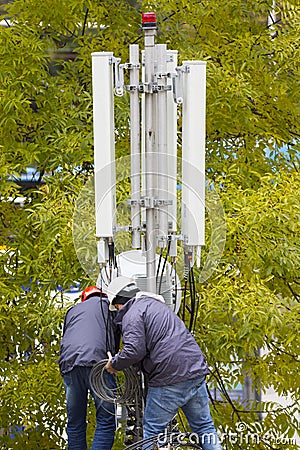 Telecommunication GSM tower workers Editorial Stock Photo