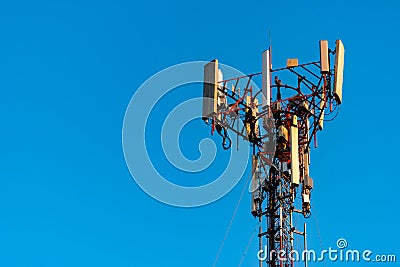 Telecommunication tower with clear blue sky background. Antenna on blue sky background. Radio and satellite pole. Communication Stock Photo