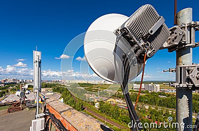 Telecommunication tower with wireless communications systems are including microwave, panel antennas, fiber, optic and power cabl Stock Photo