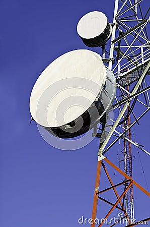 Telecommunication towers against blue sky Stock Photo
