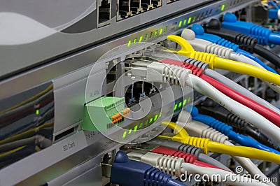 Telecommunications switches with colored patch cords Stock Photo