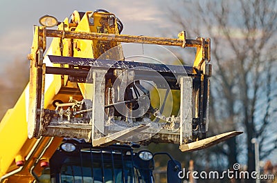 Telehandler with raised boom and forks close-up Stock Photo