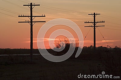 Telephone poles and sunset Stock Photo