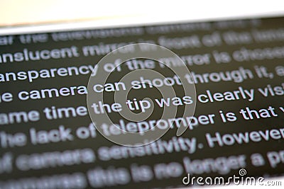 Teleprompter automatically scrolls text close-up. Stock Photo