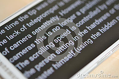 Teleprompter automatically scrolls text close-up. Stock Photo