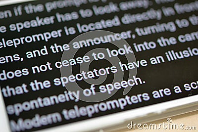 Teleprompter automatically scrolls text close-up. Stock Photo