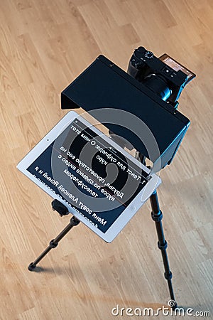 teleprompter for video. The reading text is reflected from the glass surface opposite the video camera lens Stock Photo