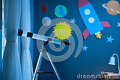 Telescope in astronomic child`s bedroom Stock Photo